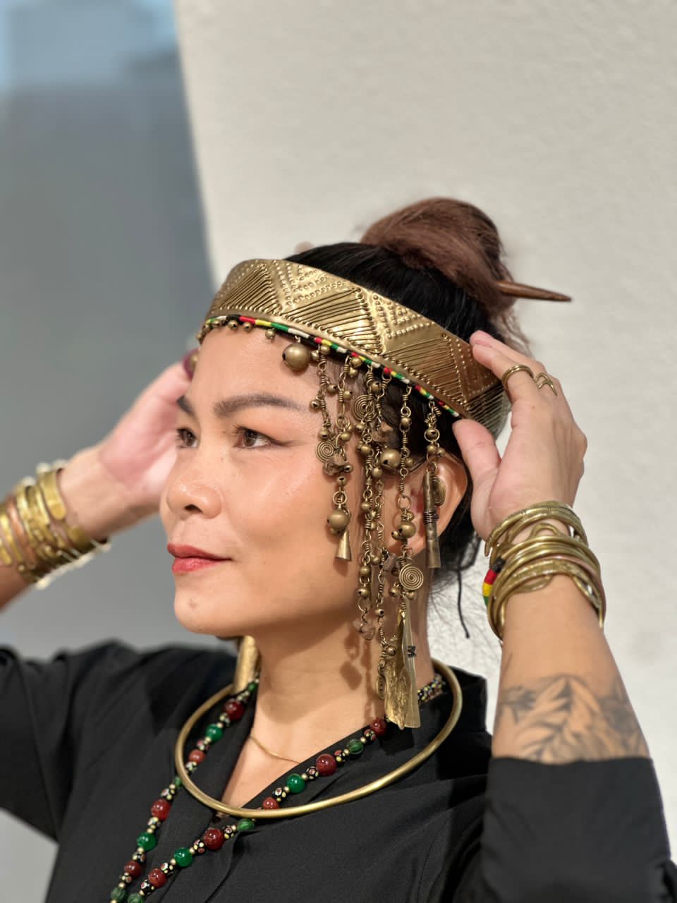 The artisan wearing her masterwork headpiece